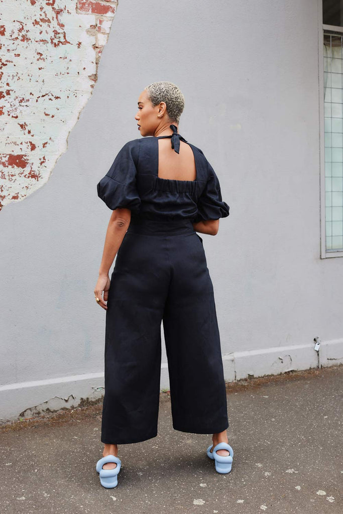 back of Collective Closets model in High waisted culottes in black linen