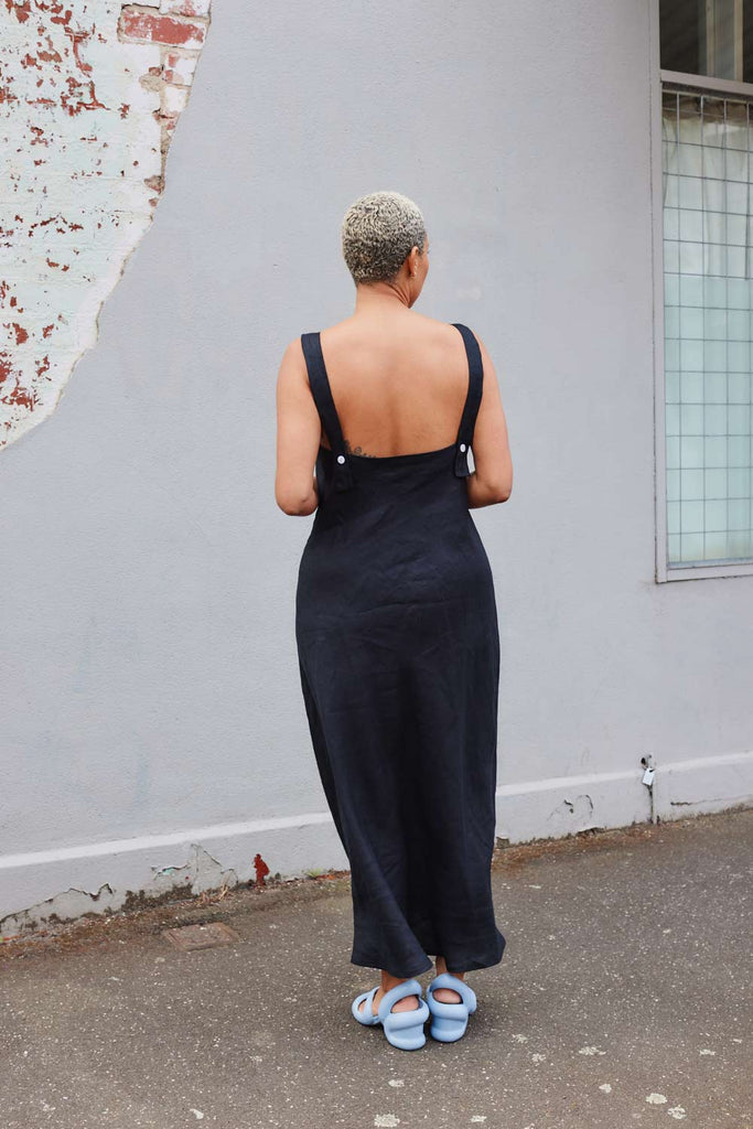 back of Collective Closets model in black linen slip dress
