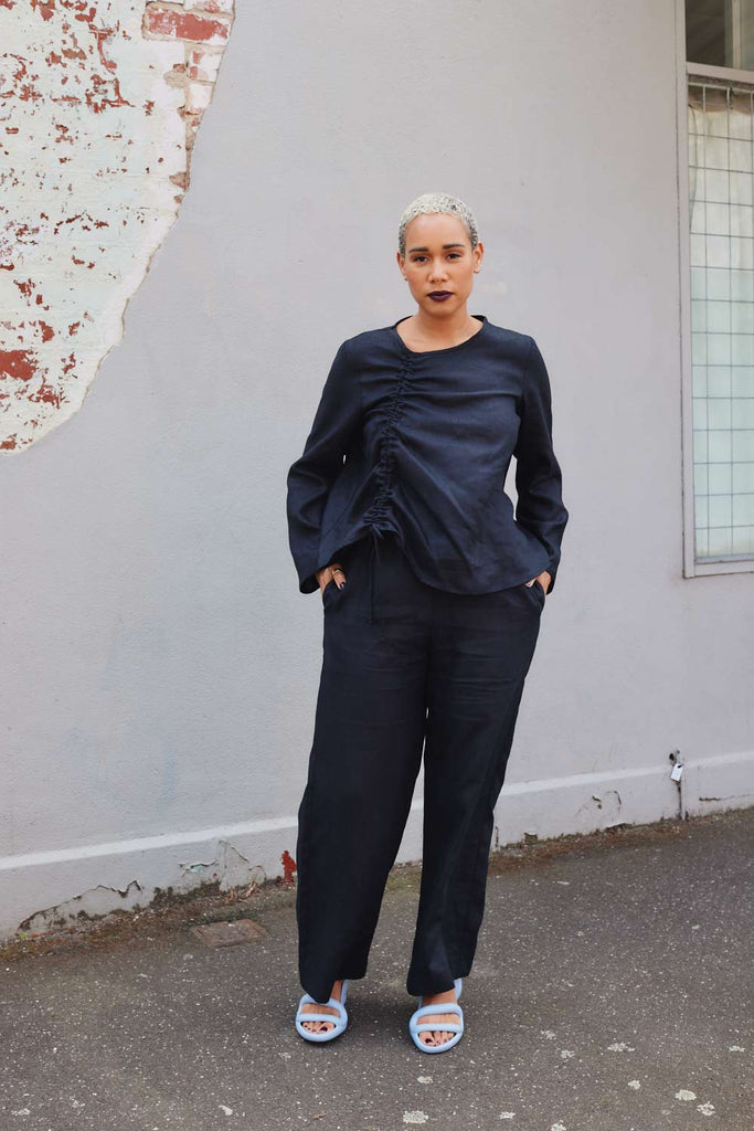 Collective Closets model wearing black linen drawsting top