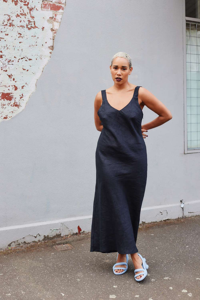 Collective Closets model in black linen slip dress with straps