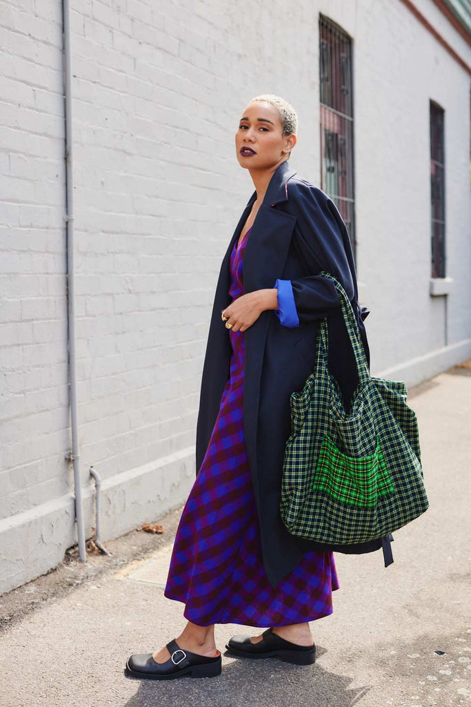 Collective Closets model in slip dress and trench coat