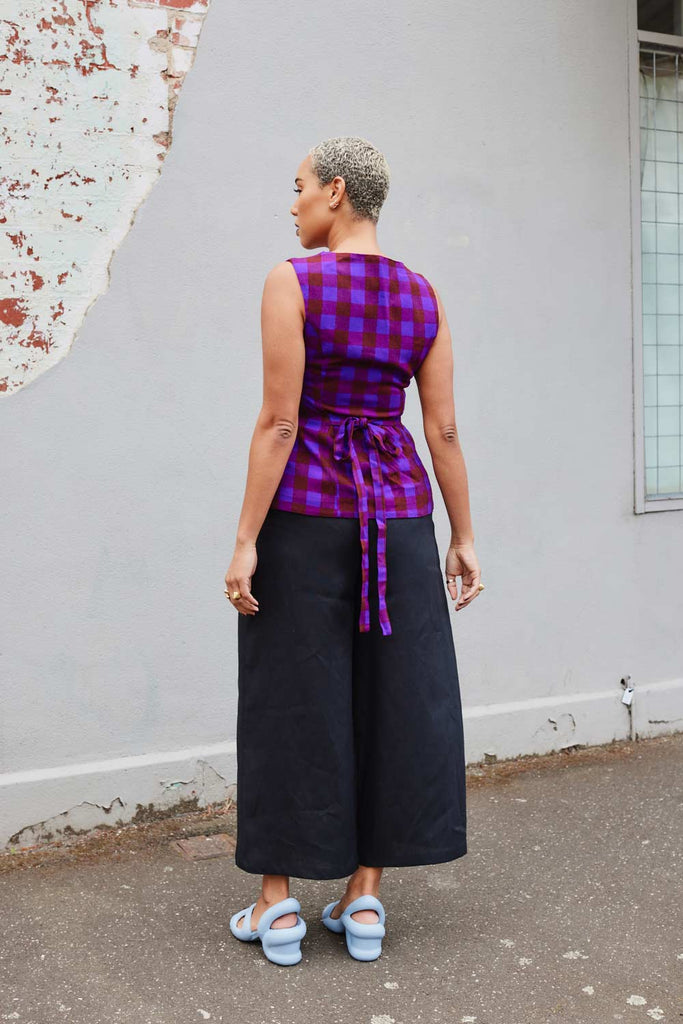 Collective Closets model from behind in purple vest