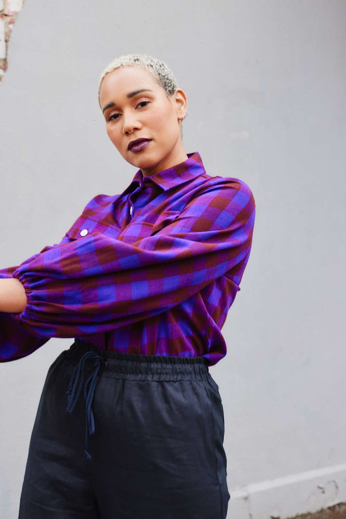 Collective Closets model in purple checked shirt with balloon sleeves